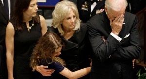 U.S. Vice President Joe Biden, right, rests his head in his hand during a viewing for his son, former Delaware Attorney General Beau Biden, Thursday, June 4, 2015, at Legislative Hall in Dover, Del. Standing with Vice President Biden are Beau Biden's widow, Hallie, from left, and daughter Natalie, and the the vice president's wife Jill. Beau Biden died of brain cancer Saturday at age 46. (AP Photo/Patrick Semansky, Pool)